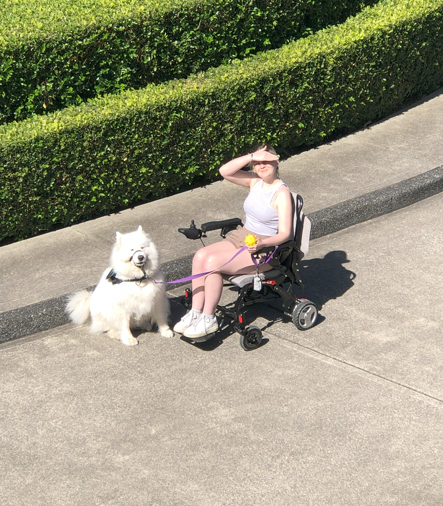 Photo of Meeka with Mikayla in wheelchair